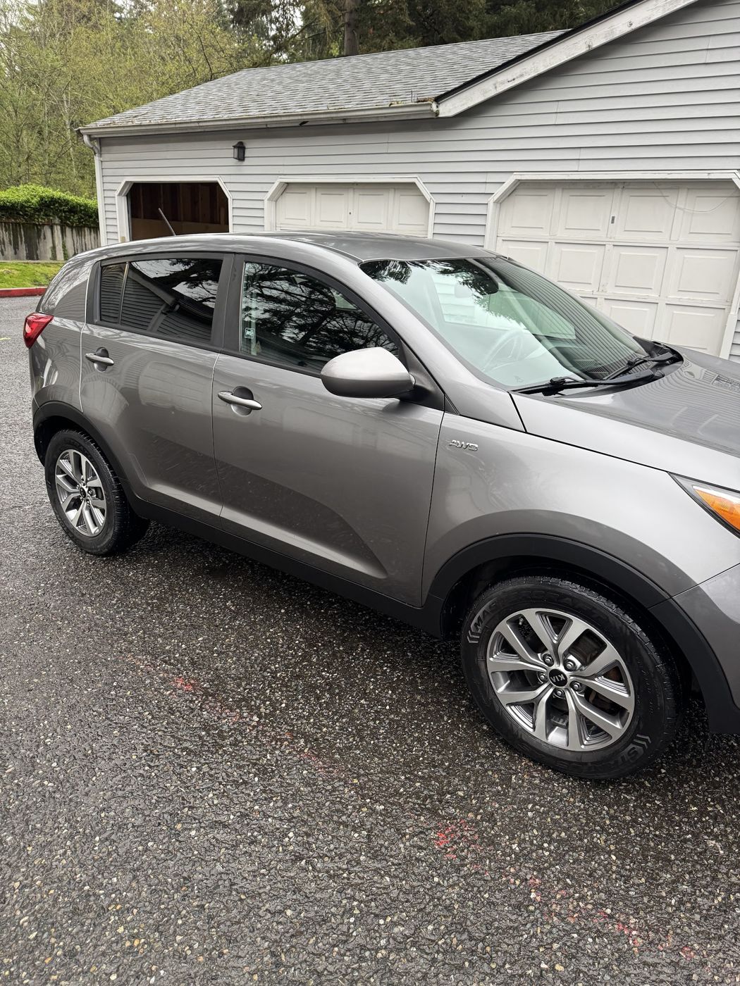Grey Kia Sportage in a driveway after a detail